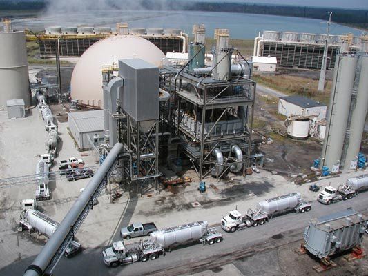 factory with trucks on the road