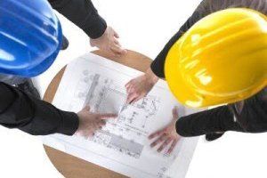 construction workers examining plans