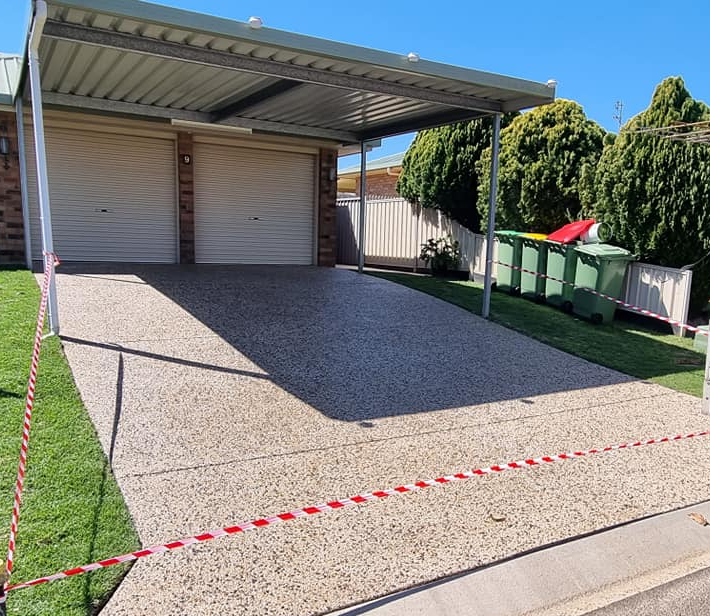 A Driveway with A Carport in Front of A House — SRS Concreting in Glenvale, QLD