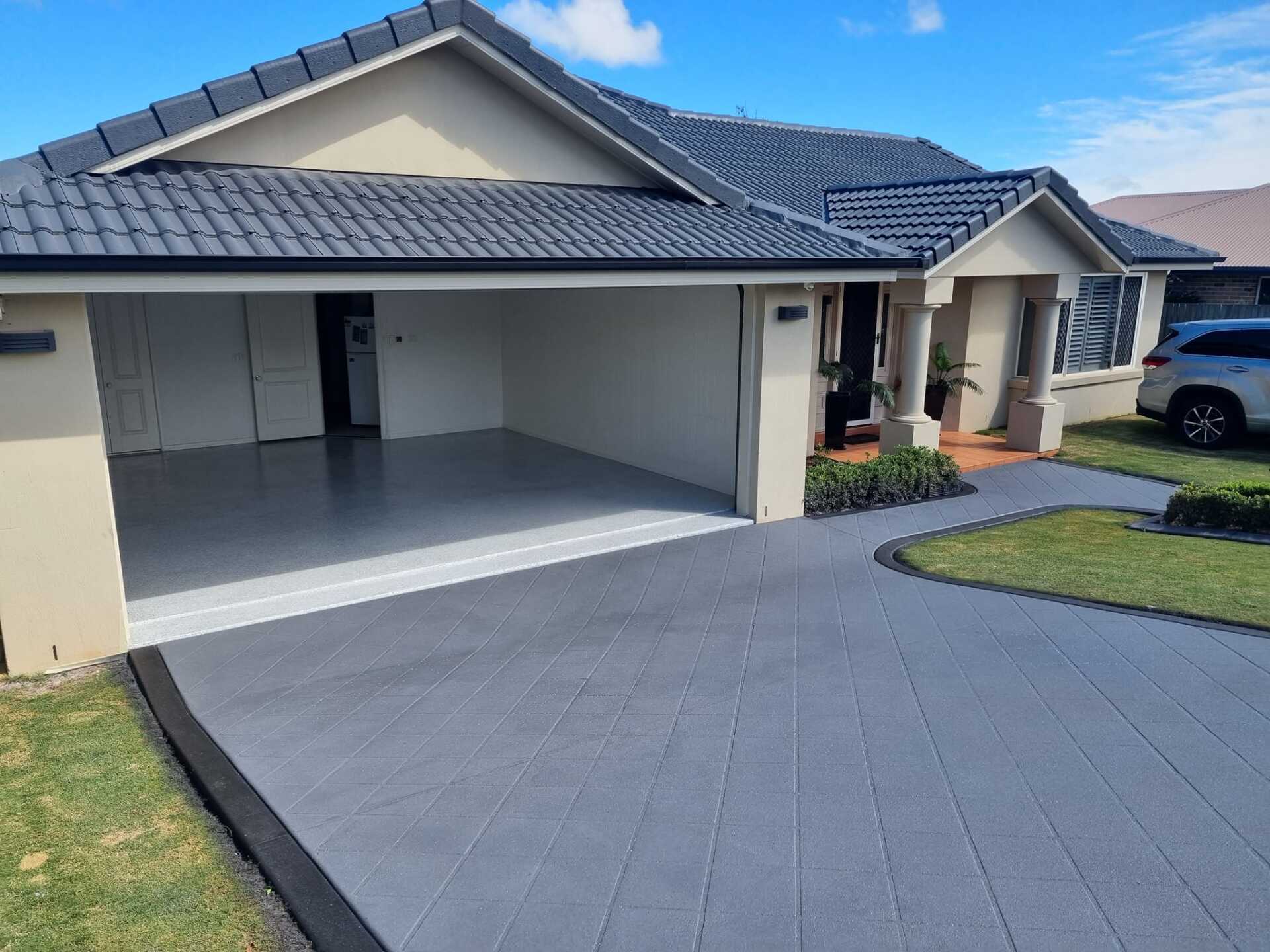 A House with A Car Parked in Front of It — SRS Concreting in Glenvale, QLD