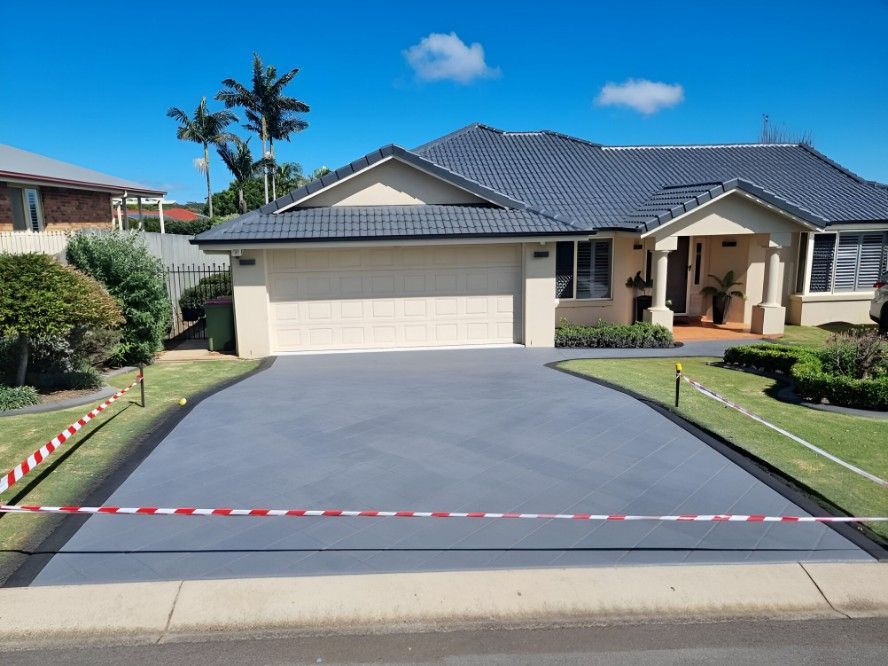 A Large House with A Concrete Driveway in Front of It https://www.srsconcreting.com/