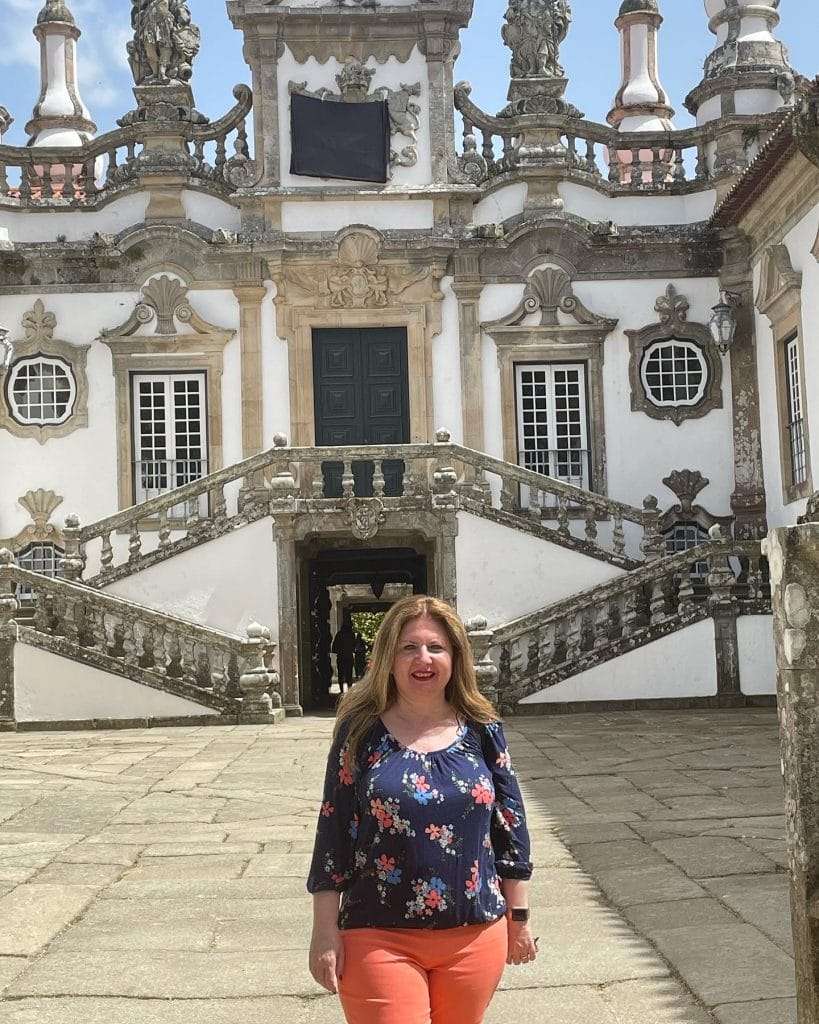 Woman standing in front of an old building — North America — Lavish Experience Travel