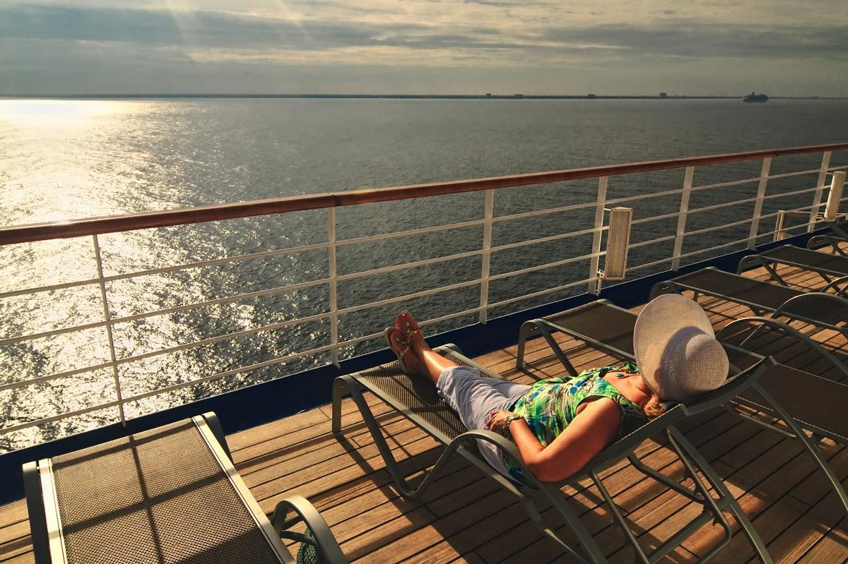 Woman relaxing on the top deck of a cruise ship — North America — Lavish Experience Travel