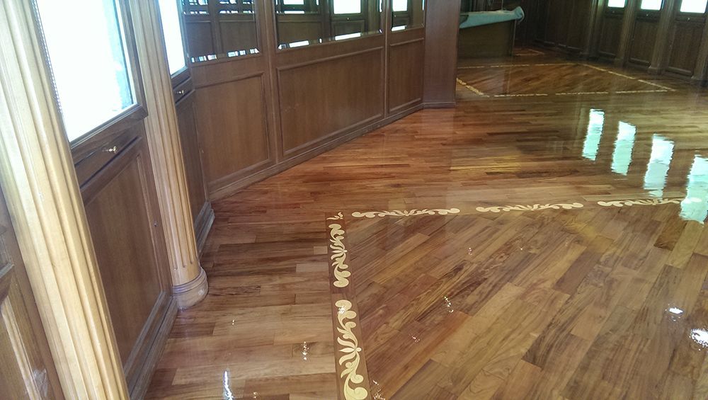 A room with a wooden floor and a lot of windows.