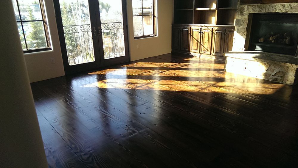 A living room with hardwood floors and a fireplace.