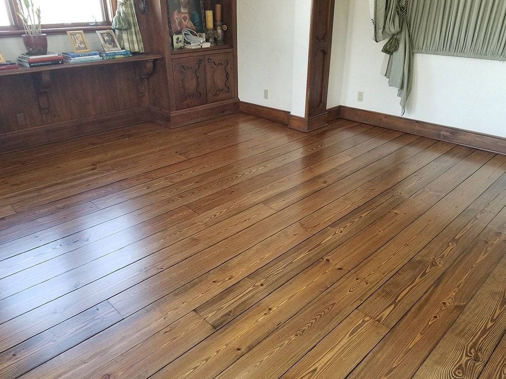 A room with a wooden floor and a window.