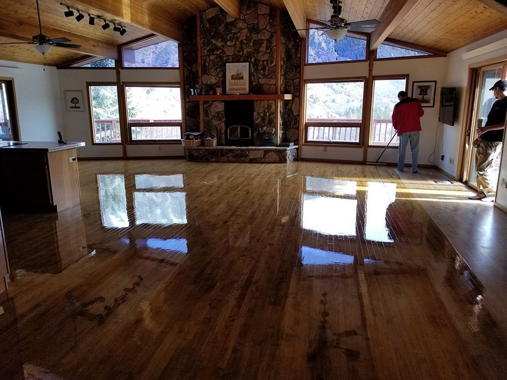 A living room with a wooden floor and a fireplace