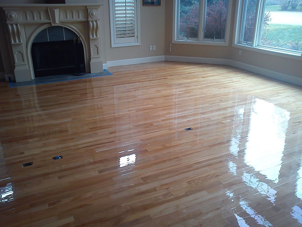 A living room with hardwood floors and a fireplace.