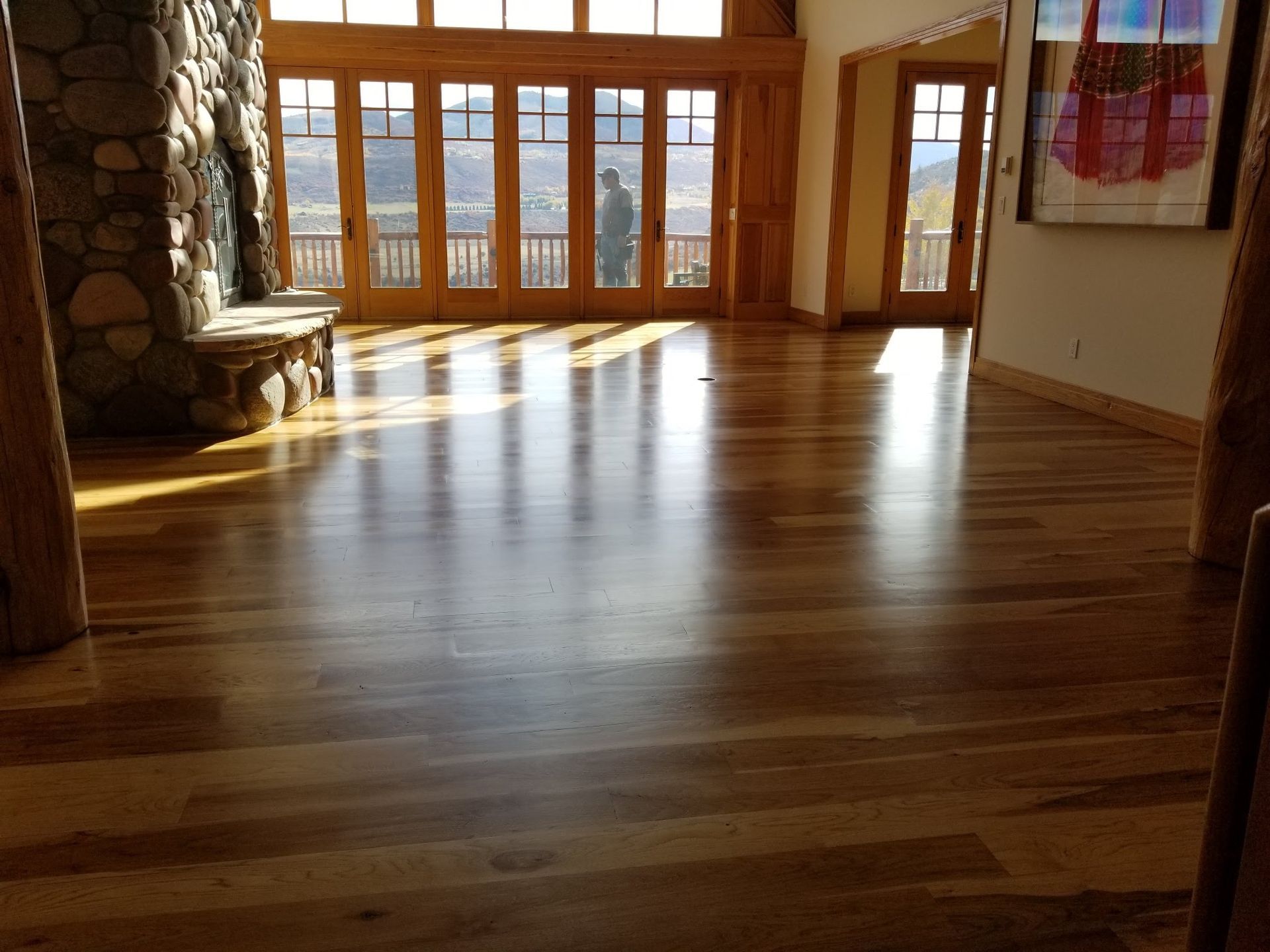 A living room with a wooden floor and a fireplace