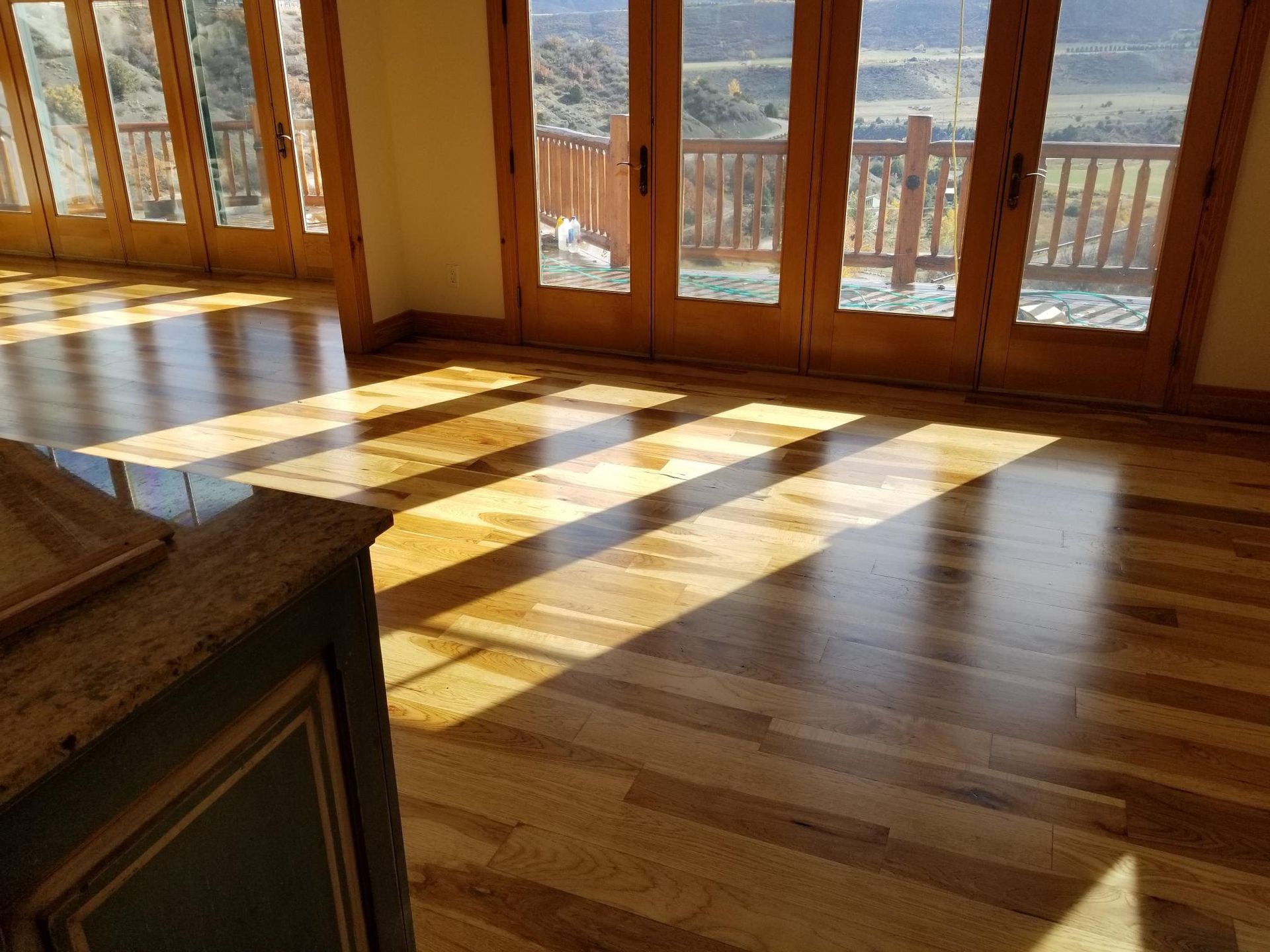 A living room with hardwood floors and sliding glass doors.