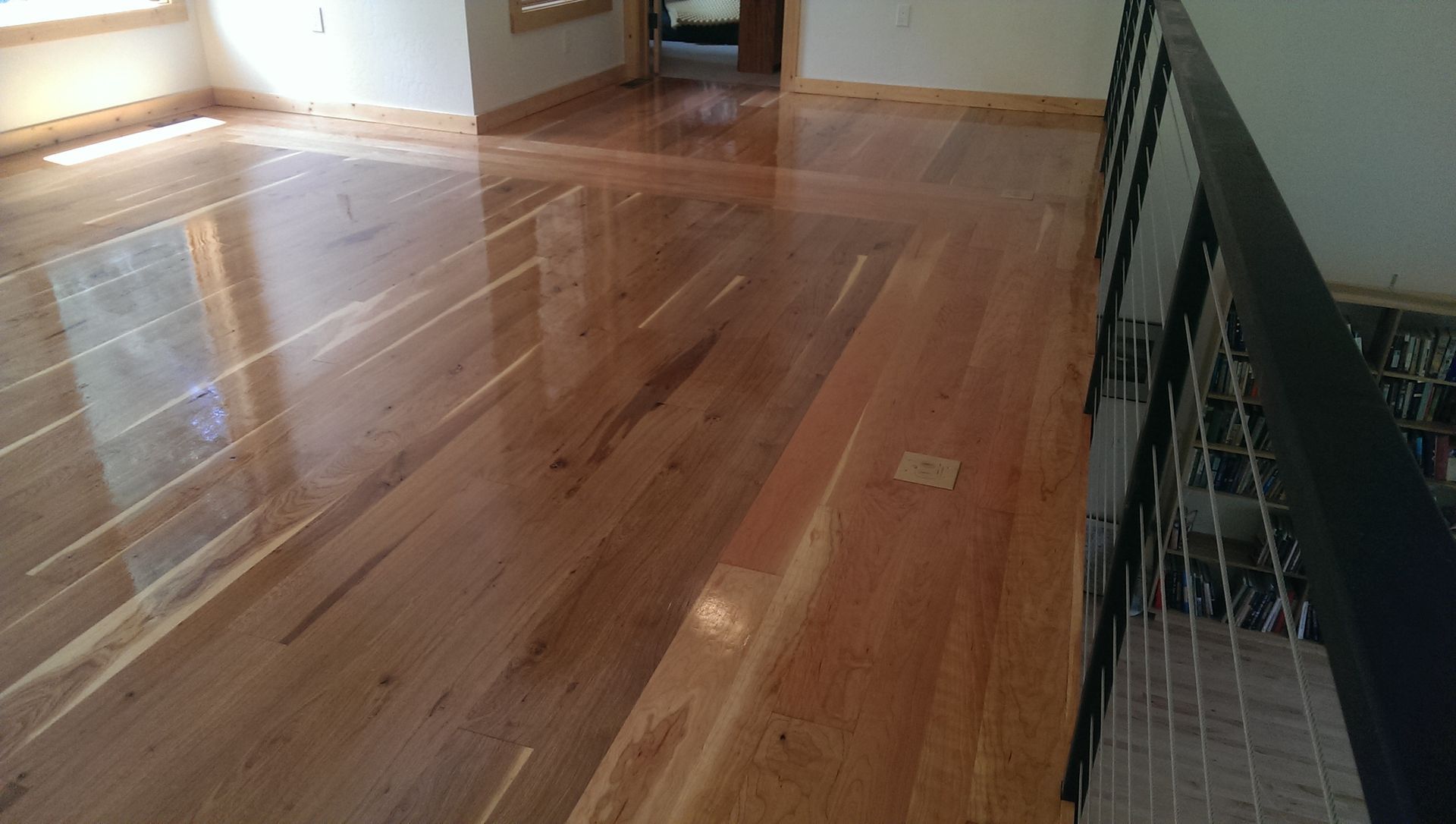 A living room with hardwood floors and a staircase.