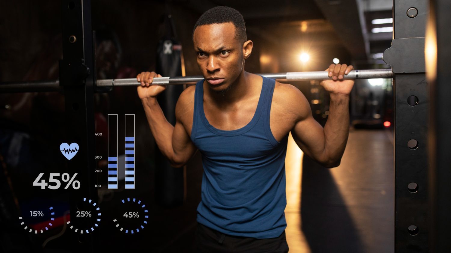 A man is squatting with a barbell on his shoulders in a gym.