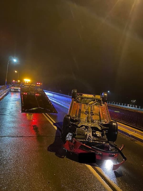 A Car is on Its Side on a Highway at Night — TNT Towing - Coffs Clarence in South Grafton, NSW