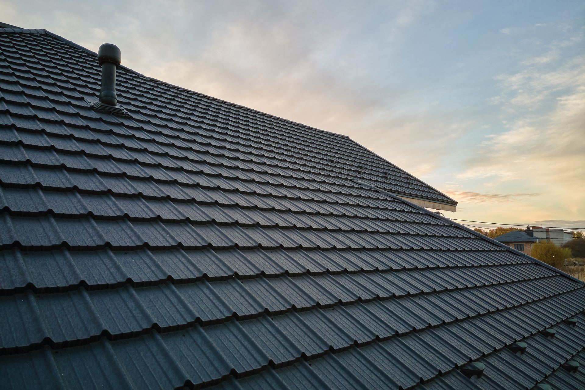A close up of a roof with a chimney on top of it.