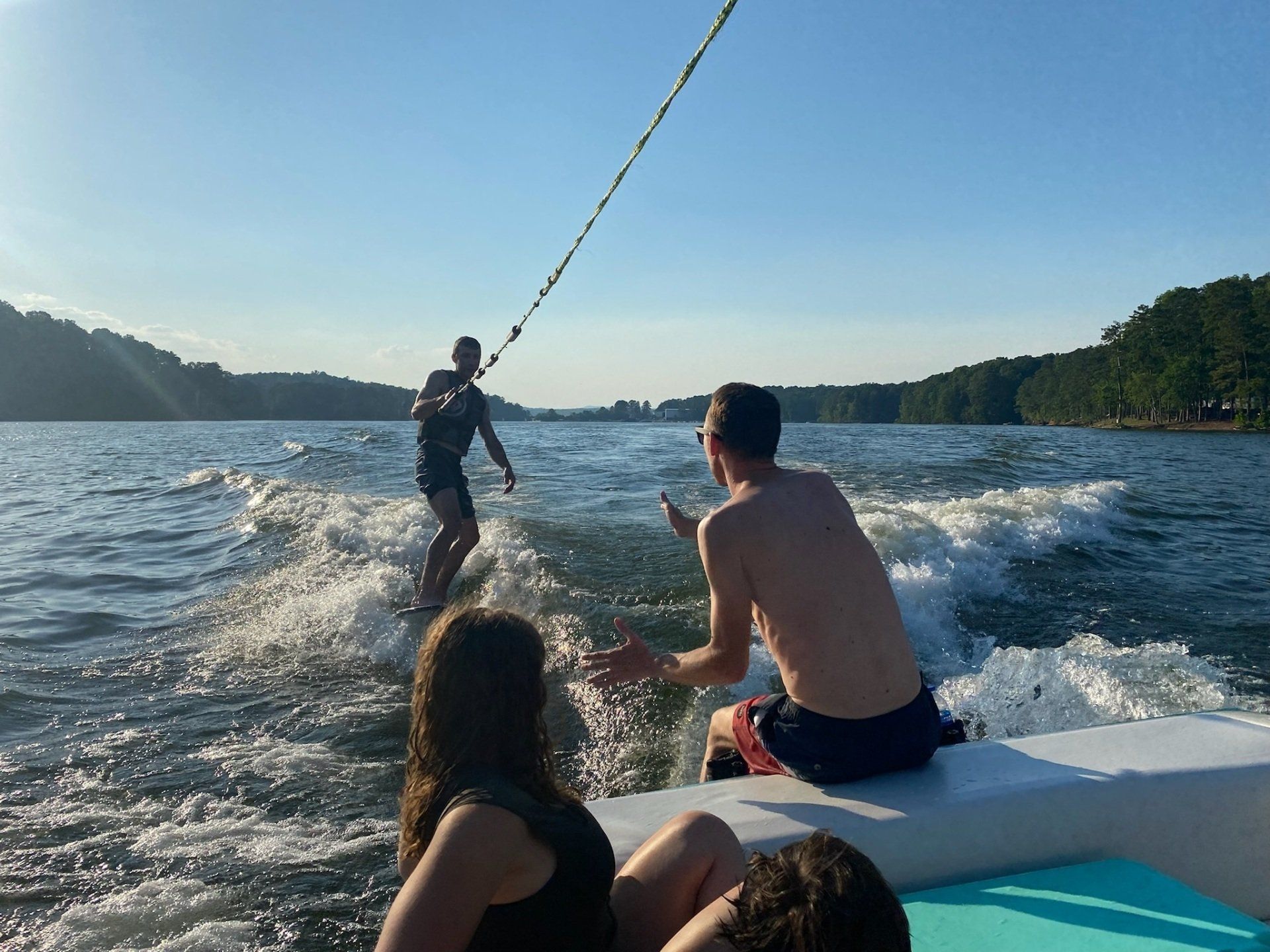 A group of people are water skiing on a lake.