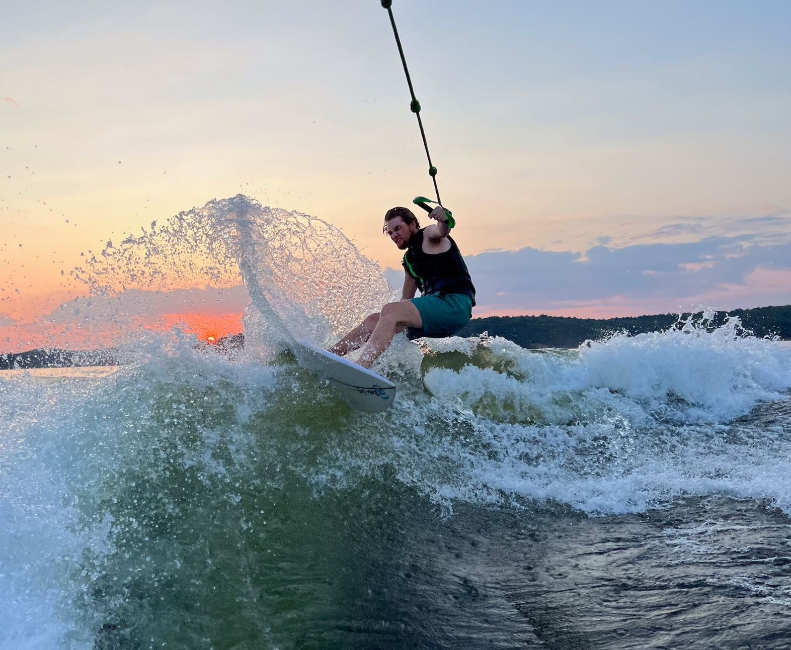 A man is riding a wave on a surfboard in the water.