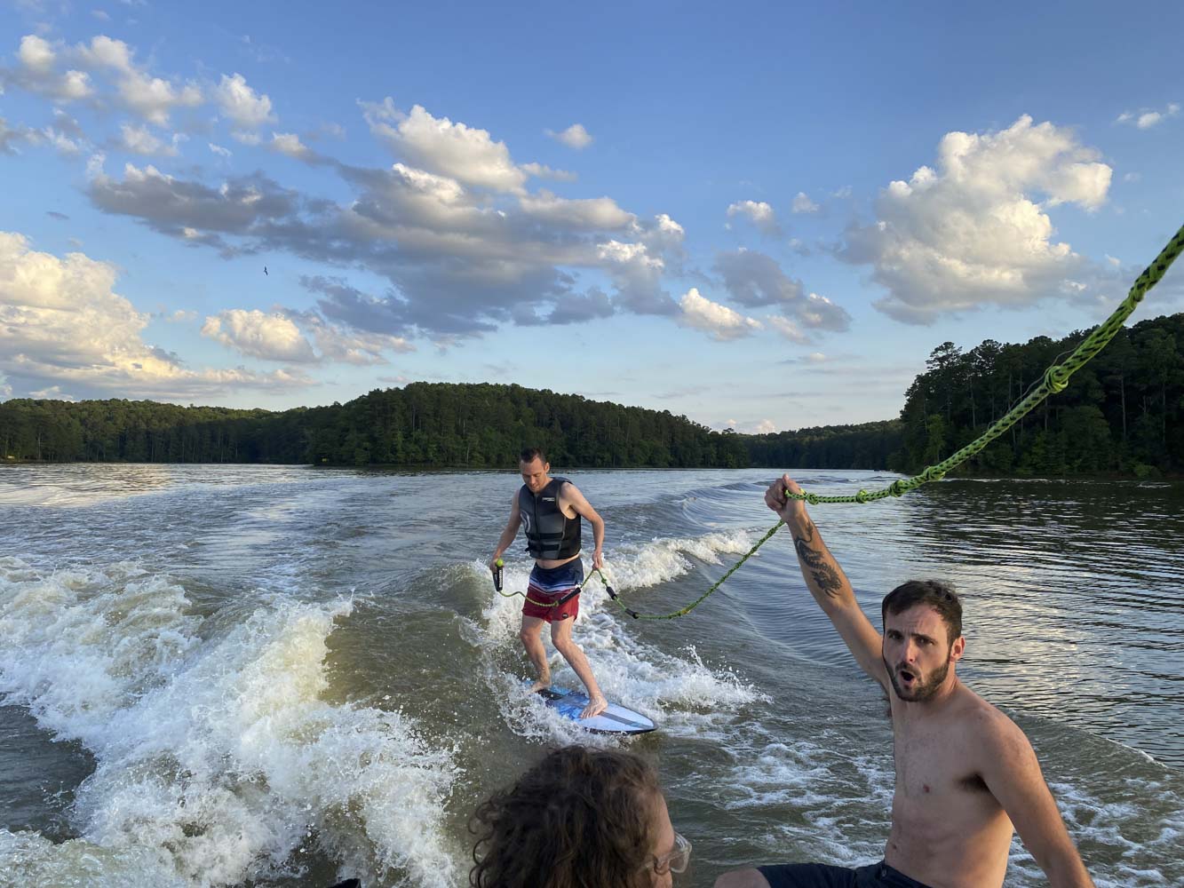 A group of people are water skiing on a lake.