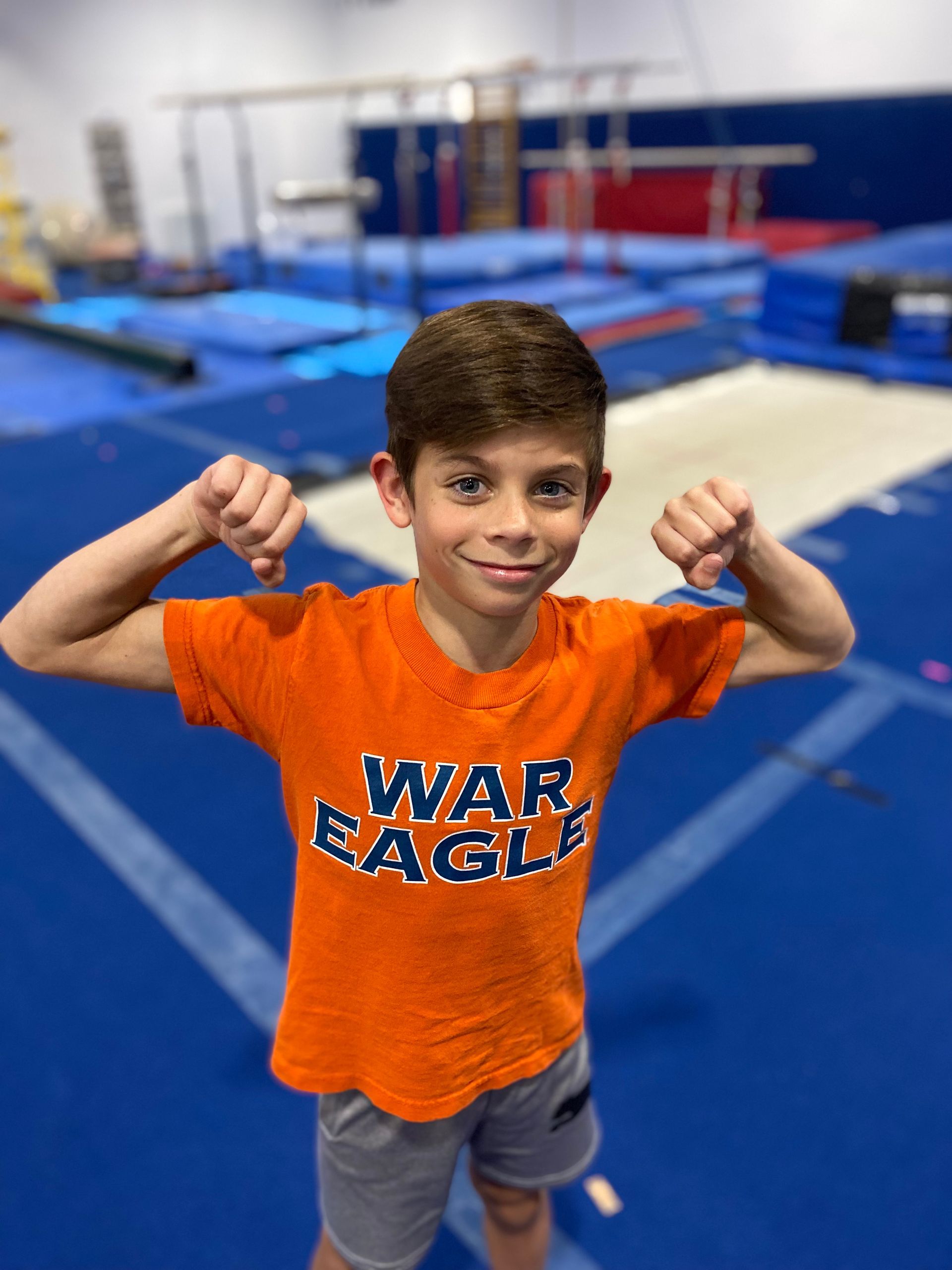 Boy flexing his arms