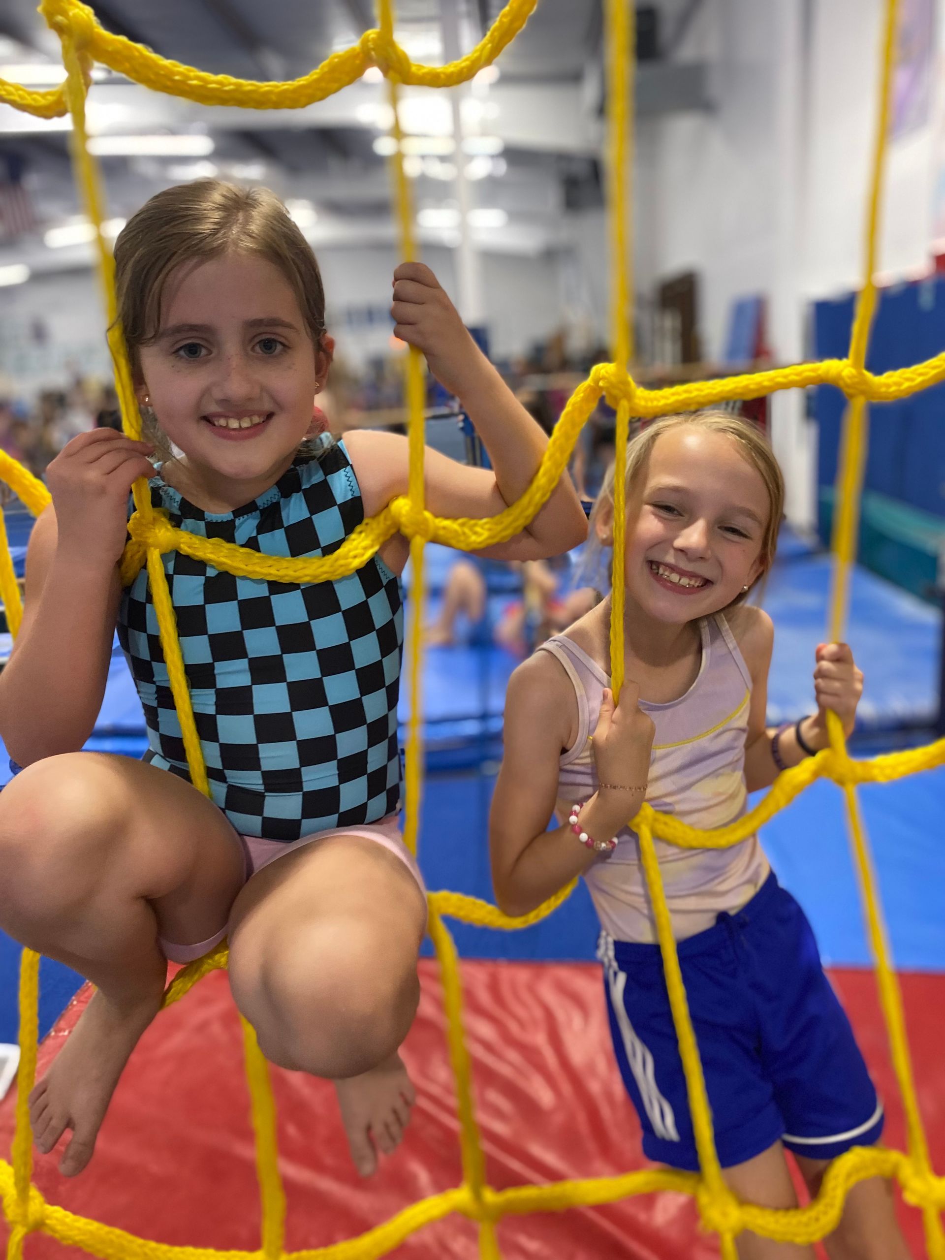 A group of young girls are sitting around a table with crayola markers.