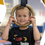 A young boy is holding a gymnastic ring over his head.