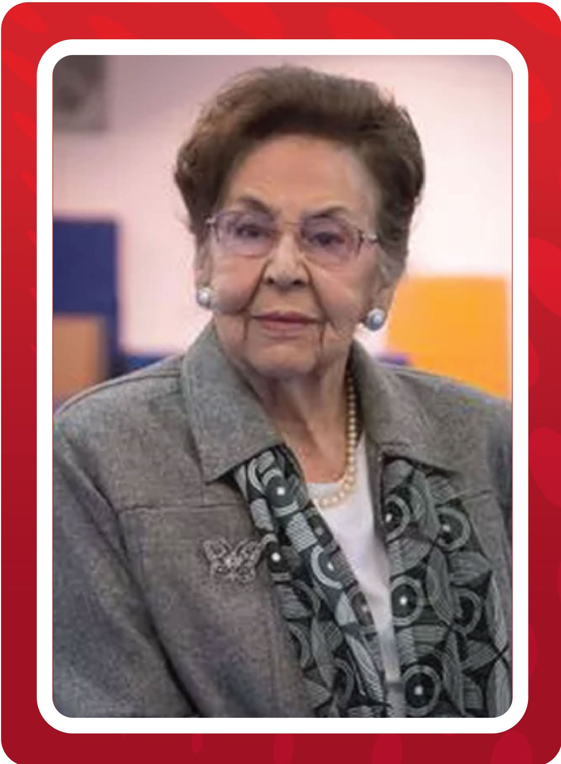 An woman wearing glasses and a gray jacket