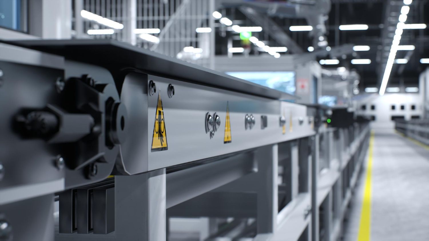 A conveyor belt in a factory with a yellow line on the floor.