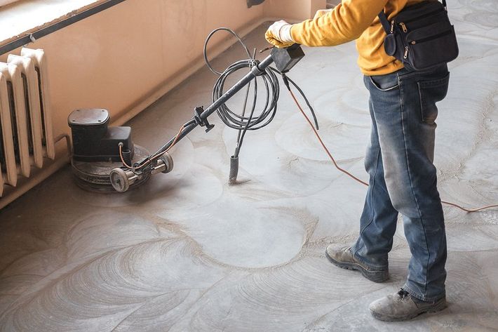 someone polishing the concrete flooring