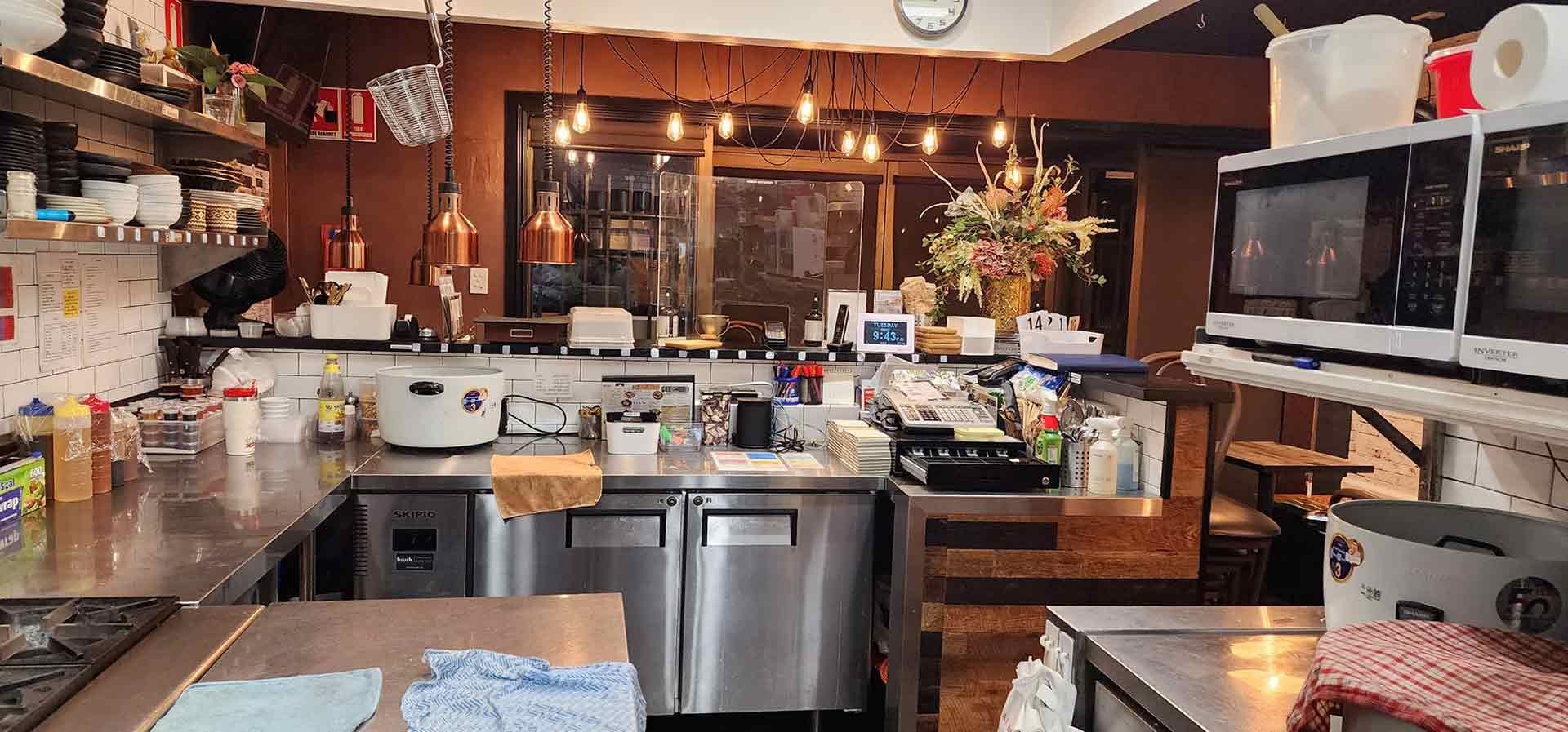 A Kitchen With A Lot Of Stainless Steel Appliances And A Sink — Dan's Pest Control in Dapto, NSW