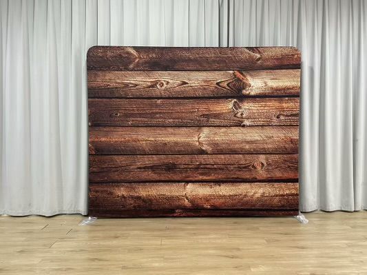 A wooden wall behind a white curtain in a room.