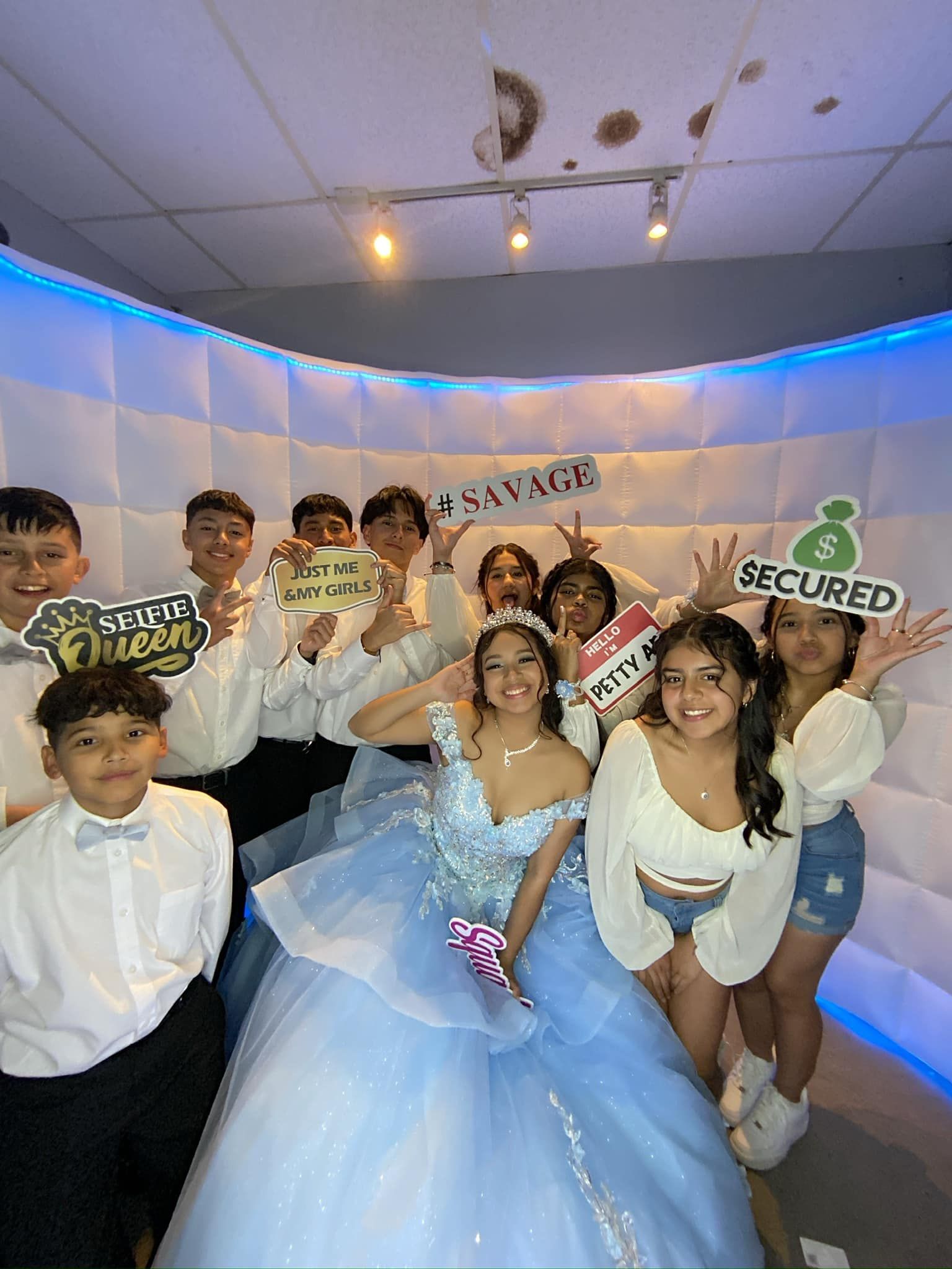 A group of people are posing for a picture in a photo booth.