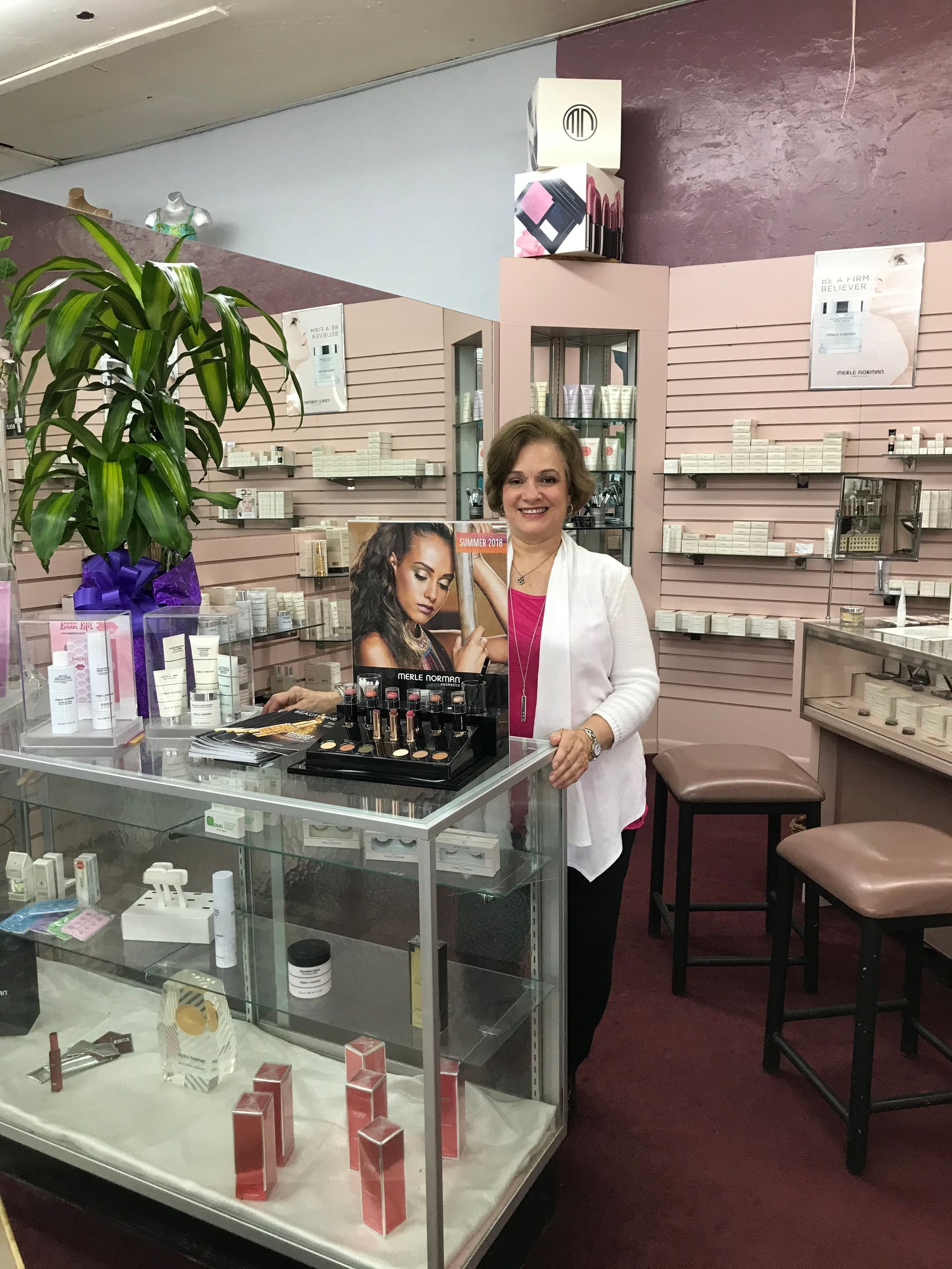 Black makeup brush with a cap on a tan surface.
