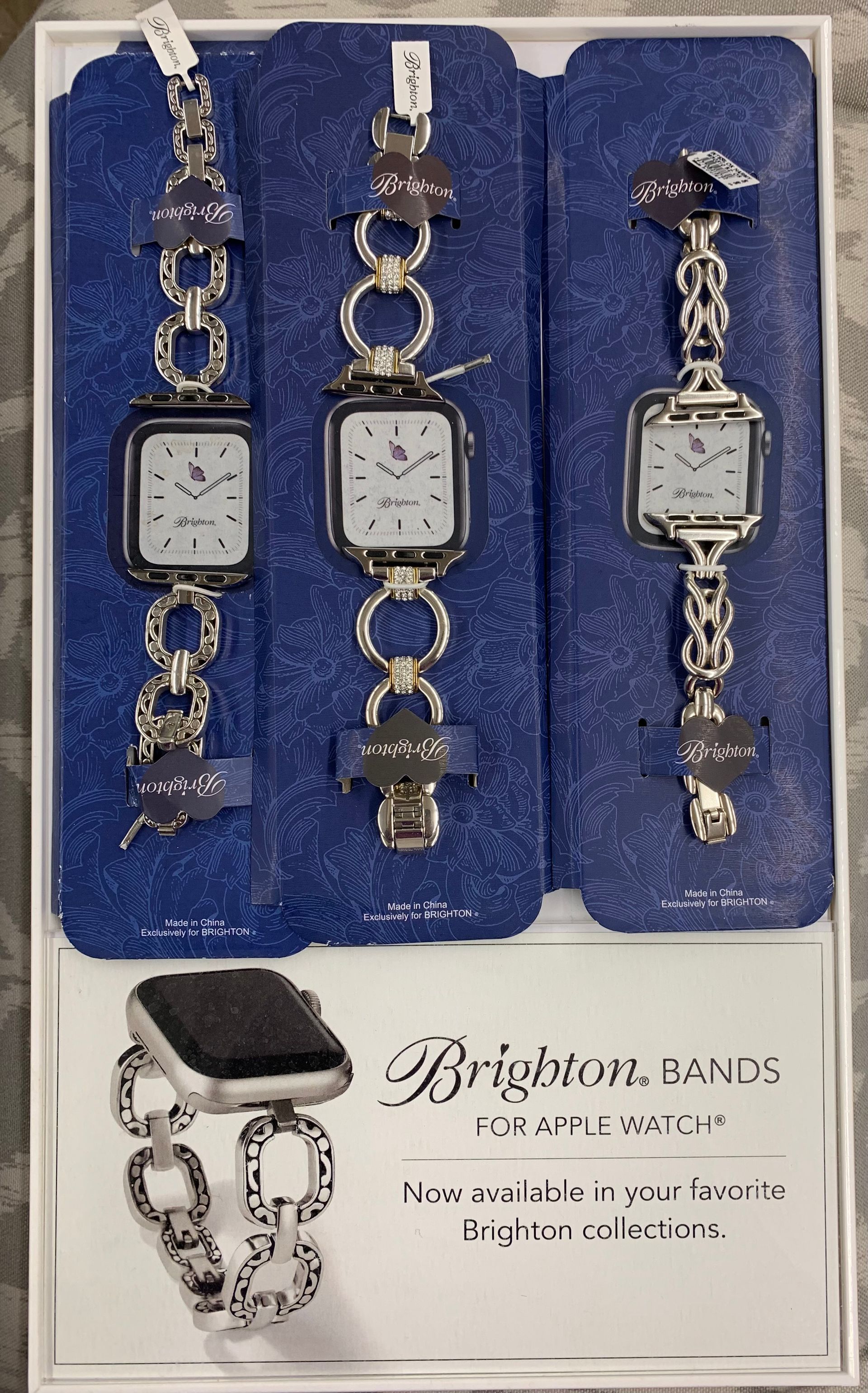 Display of three Brighton watch bands for Apple Watch with silver link designs.