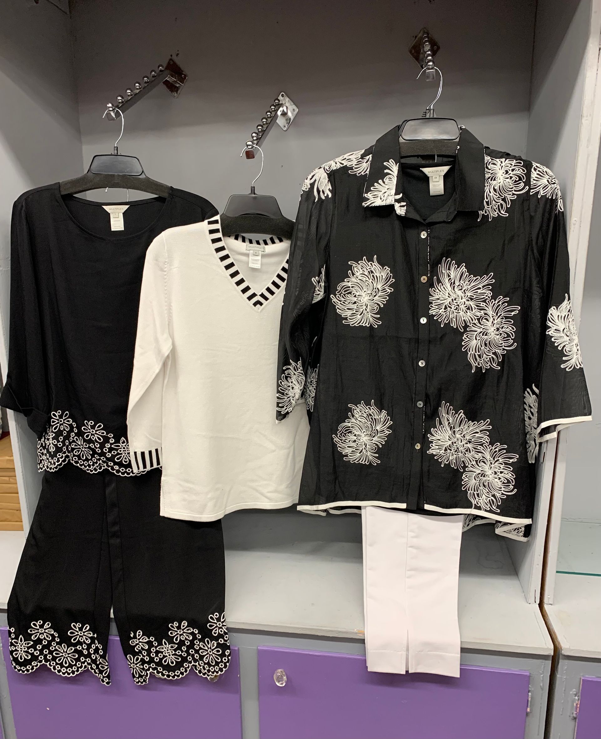 Outfit on pink background: light blue top, distressed jeans, white sneakers, hat.