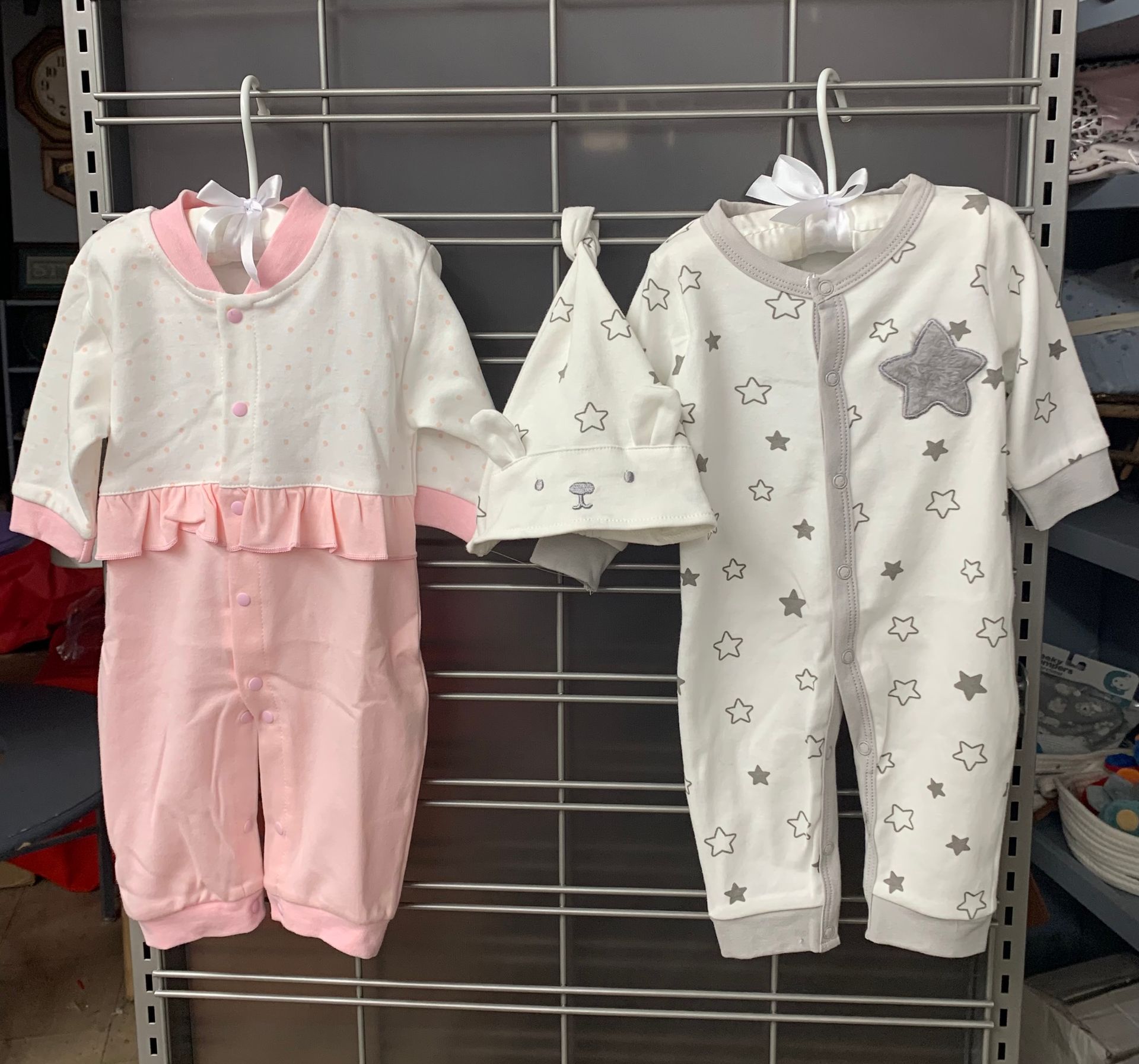 Light blue baby shoes on a folded denim shirt and pants.