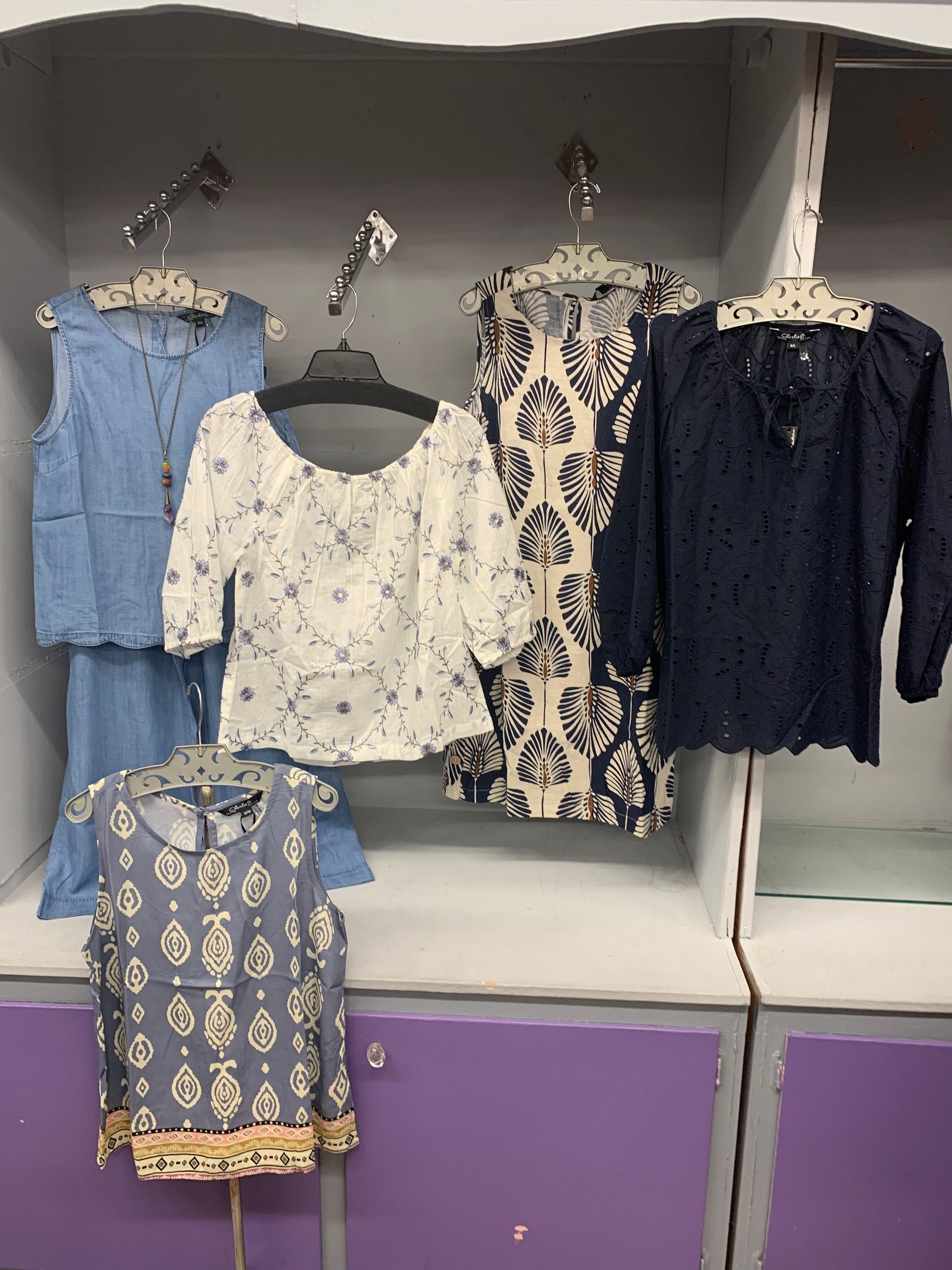Yellow summer dress outfit with sandals, bag, sunglasses, and jewelry on wood.