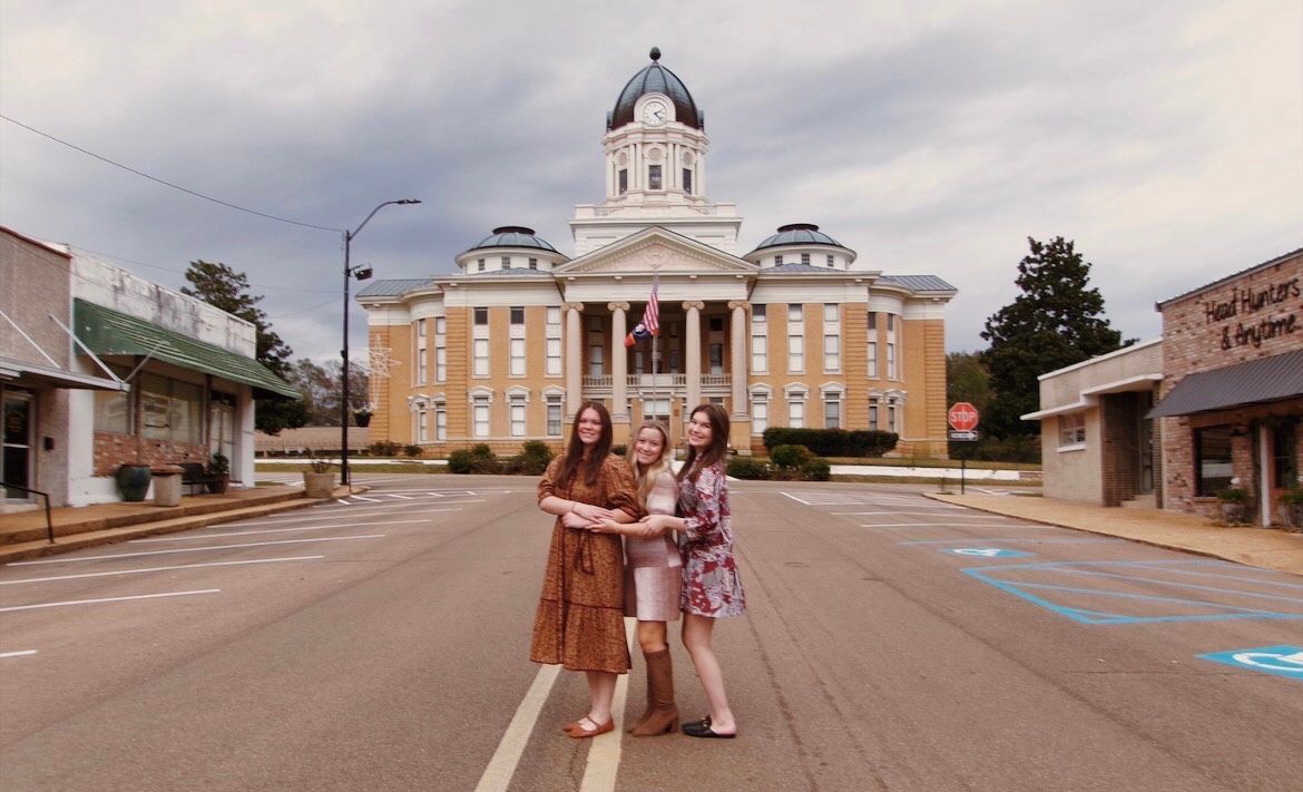 Jewelry: two-tone gold and silver bracelets and a chain bracelet, arranged with stacked stones on a neutral background.