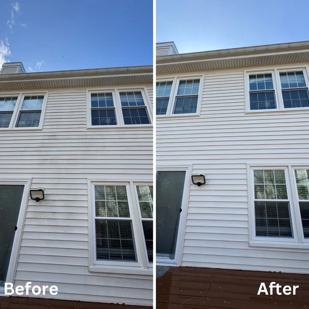 Before and after photos of a two-story house. Siding is cleaned from dirty and stained to white. Clear sky.