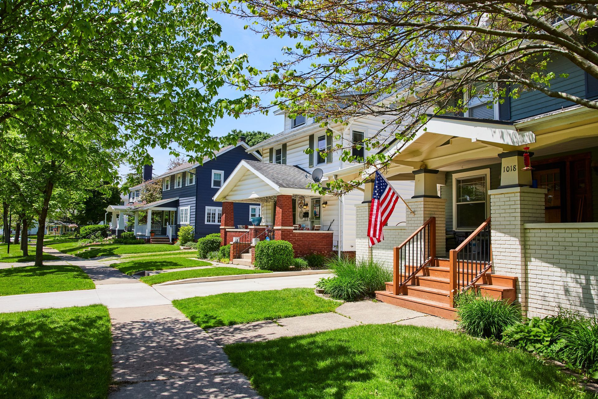 A row of houses with a flag on the front of one of them.