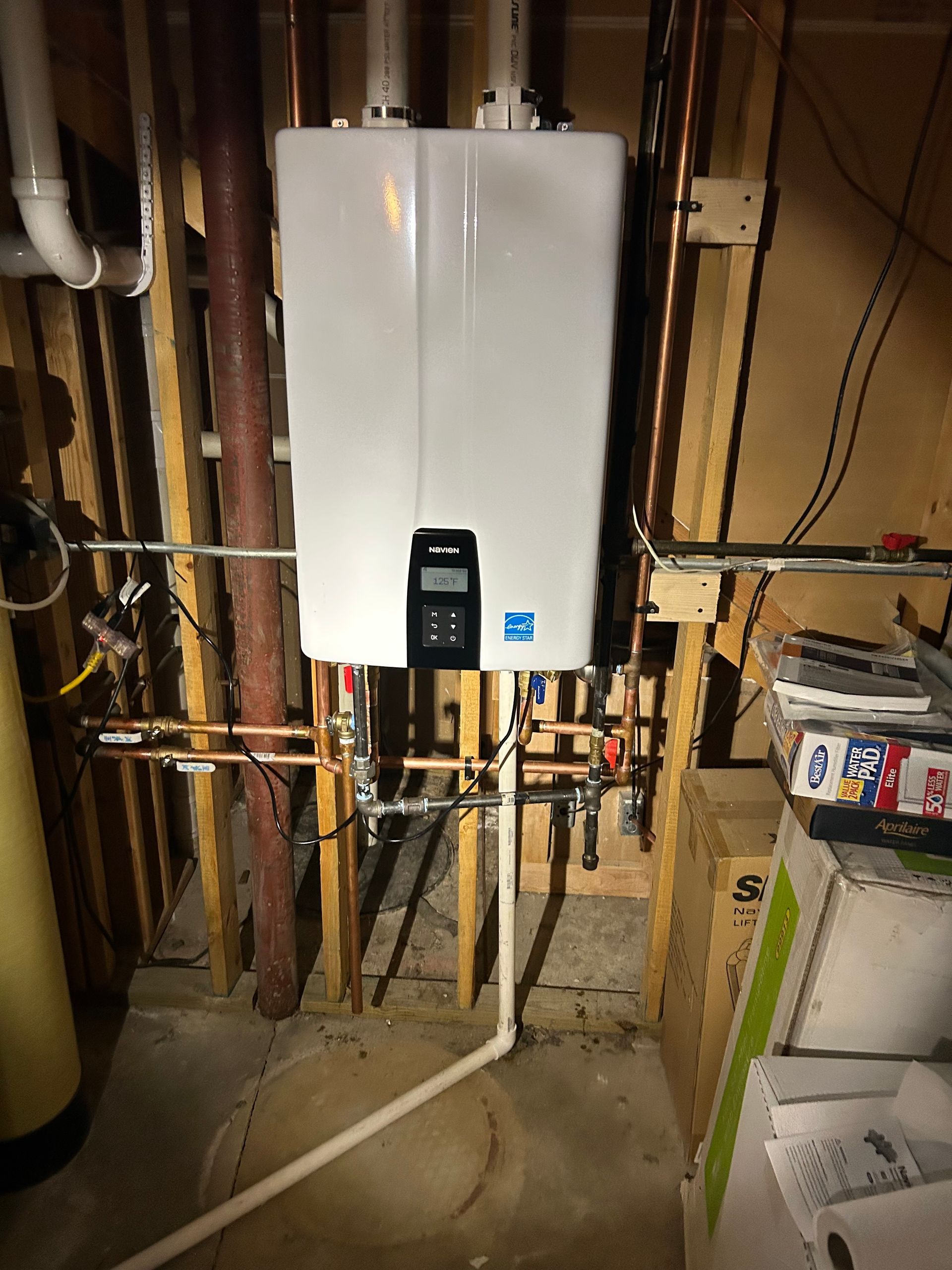 Person using a screwdriver on a hot water heater.