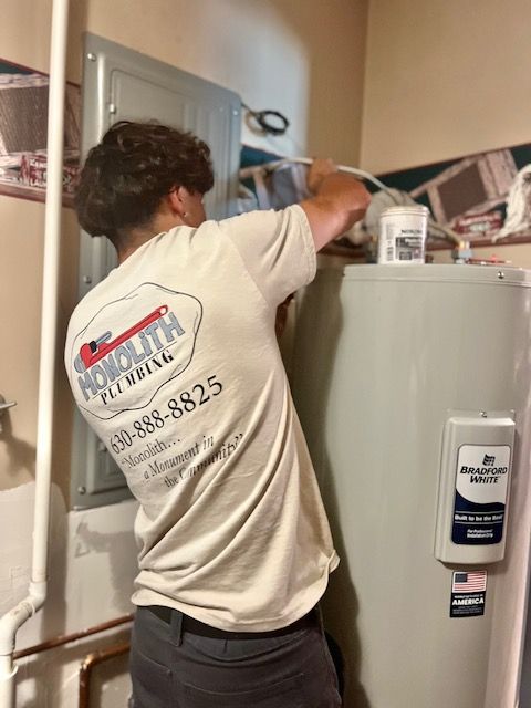 Person repairing a white wall-mounted boiler, manipulating internal components. Blue and red pipes are visible.