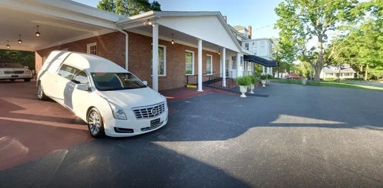 Side view with hearse at McReynolds-Nave & Larson Funeral Home in Clarksville, TN.