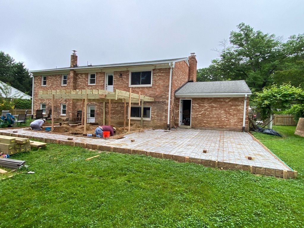 Brick house with new paved patio and detached garage, front yard under renovation