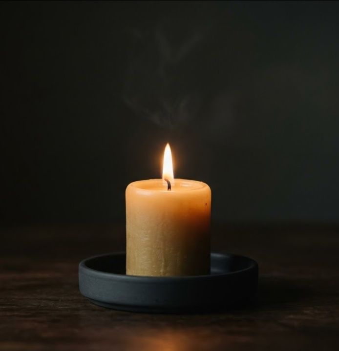 Single candle burning in dark setting, funeral homes in Colchester, VT
