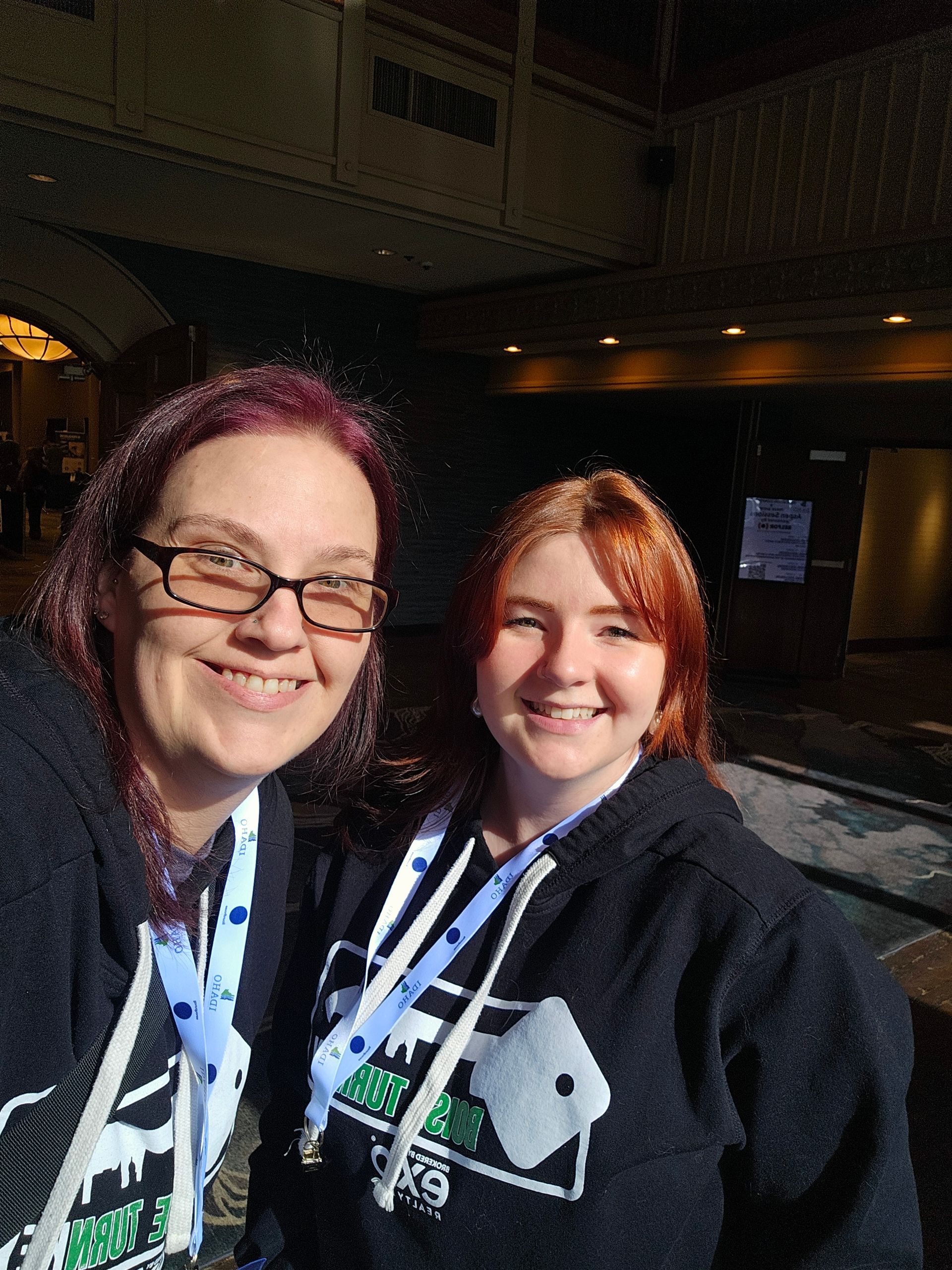 Two women are posing for a picture and one of them is wearing glasses.