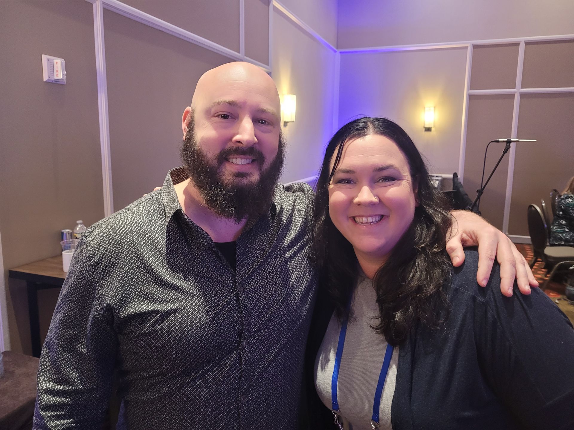 A man with a beard is posing for a picture with a woman.