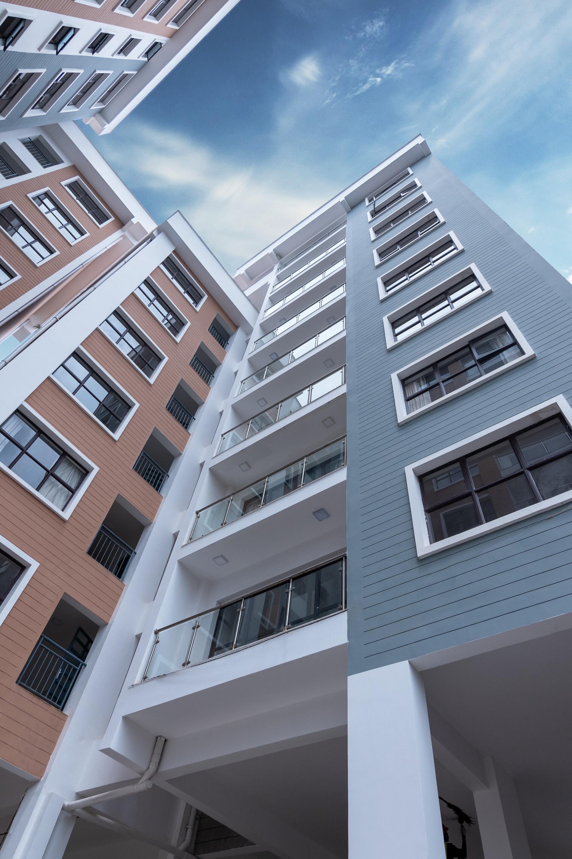 Looking up at a tall building with a blue sky in the background