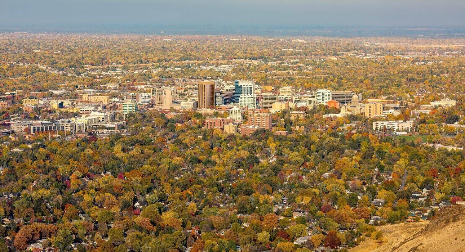 An aerial view of a city surrounded by trees and buildings.