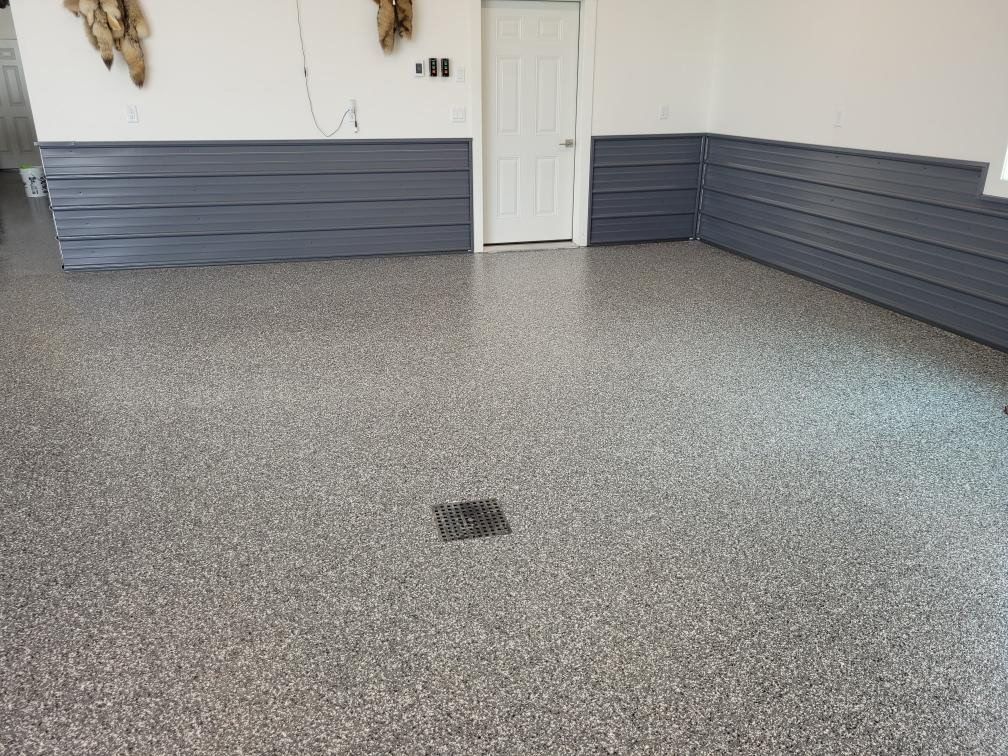 A garage with a concrete floor and a door.