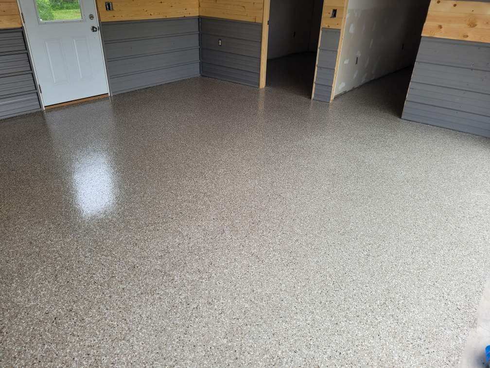 A garage with a shiny concrete floor and a door.