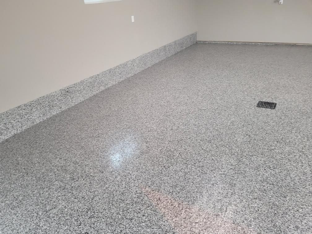 A garage with a gray floor and white walls.